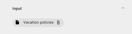Dieser Screenshot zeigt die Büroklammer im Chip eines referenzierten Objekts markiert, wo ein Klick das Öffnen dessen Anlage bewirkt.